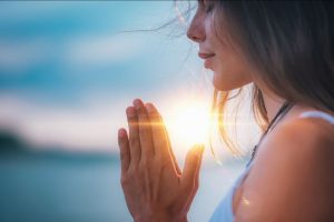 young-woman-eyes-closed-hands-in-prayer-position-768